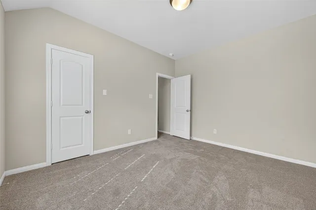 a view of an empty room with closet area