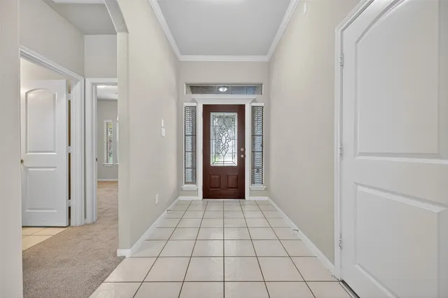 an empty room with chandelier fan and windows