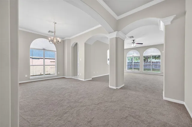 an empty room with chandelier outdoor and seating