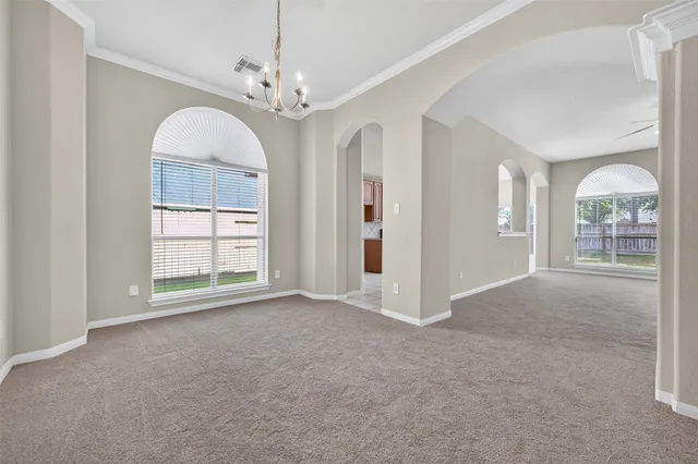 a view of a chandelier fan and entryway