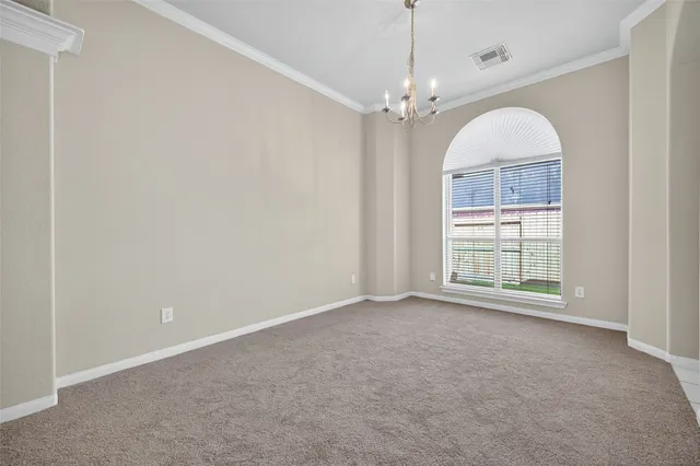 an empty room with windows and outdoor view
