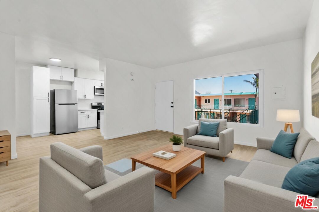 7825 West Manchester Avenue, Unit 23 Playa del Rey, CA 90293 - Photo 5 of 14 a living room with furniture and a table