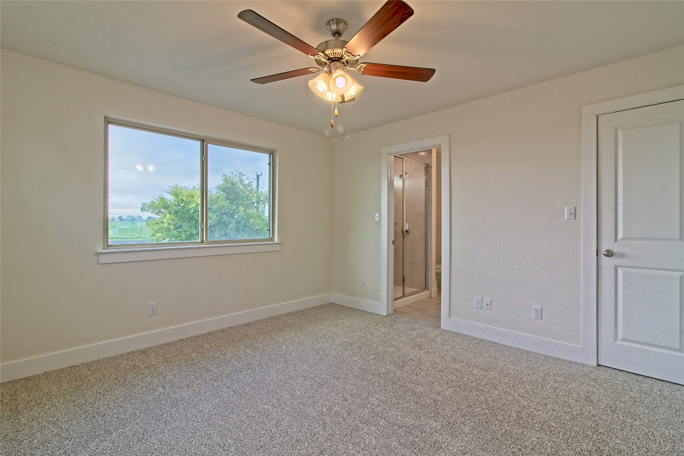 555 White Steppe Way Georgetown, TX 78626 - Photo 20 of 40 Unfurnished bedroom featuring light carpet, a ceiling fan, and ensuite bathroom