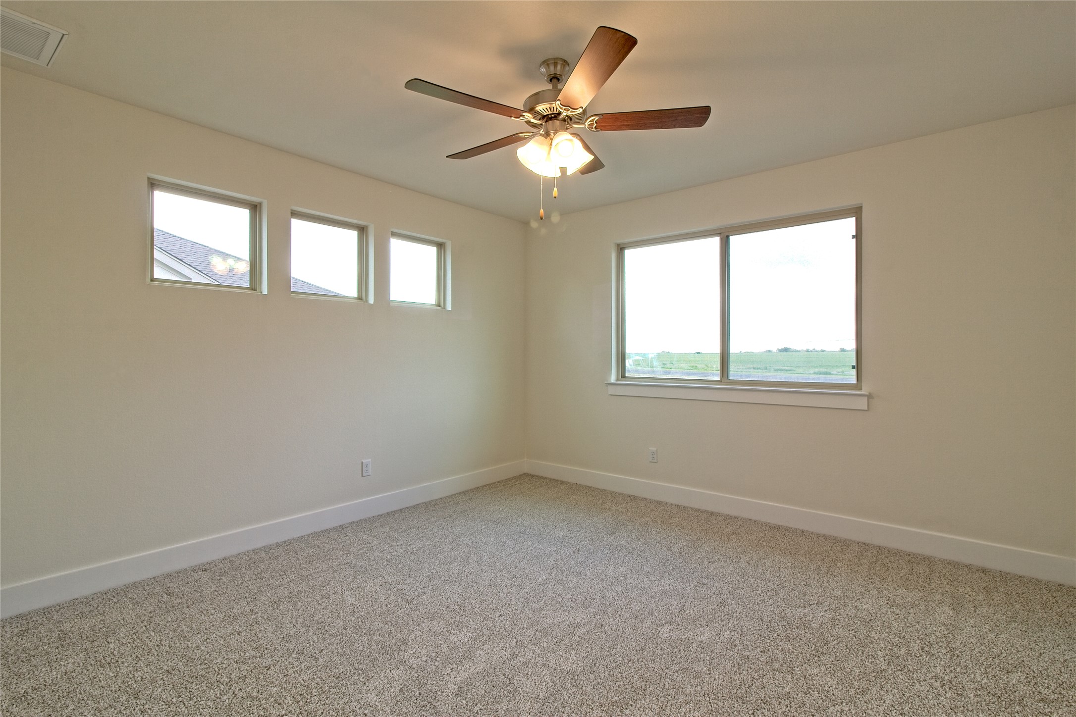 555 White Steppe Way Georgetown, TX 78626 - Photo 21 of 40 Carpeted empty room featuring plenty of natural light and ceiling fan