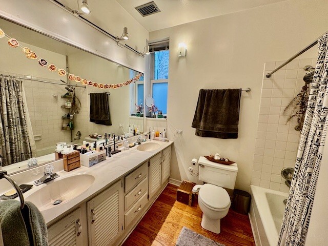 Undisclosed Address Chicago, IL 60614 - Photo 15 of 20 a bathroom with a double vanity sink toilet mirror and shower