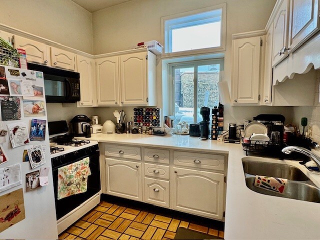 Undisclosed Address Chicago, IL 60614 - Photo 10 of 20 a kitchen with cabinets appliances a sink and a counter top space
