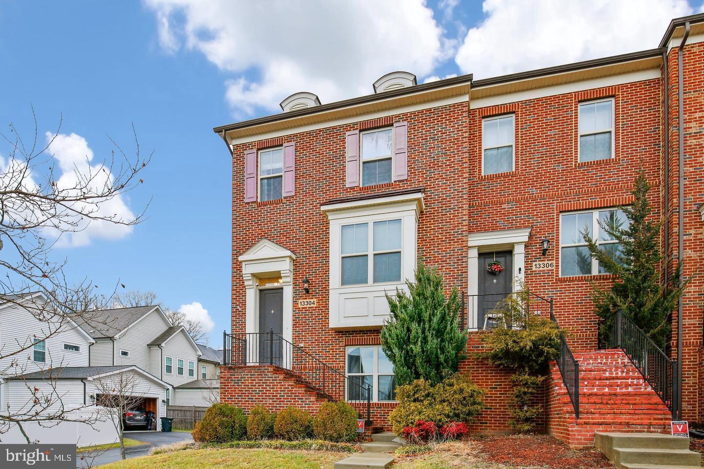 a front view of a residential houses with yard