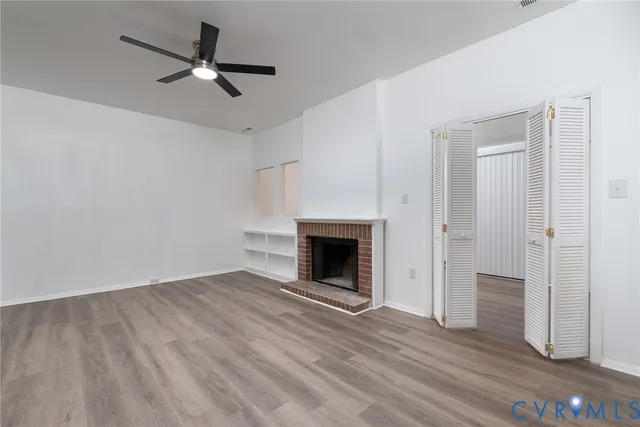 wooden floor in an empty room with a fireplace