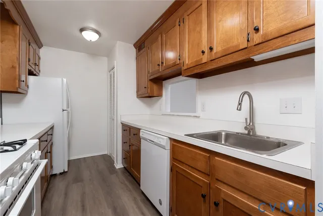 a kitchen with stainless steel appliances granite countertop a sink a stove and a refrigerator