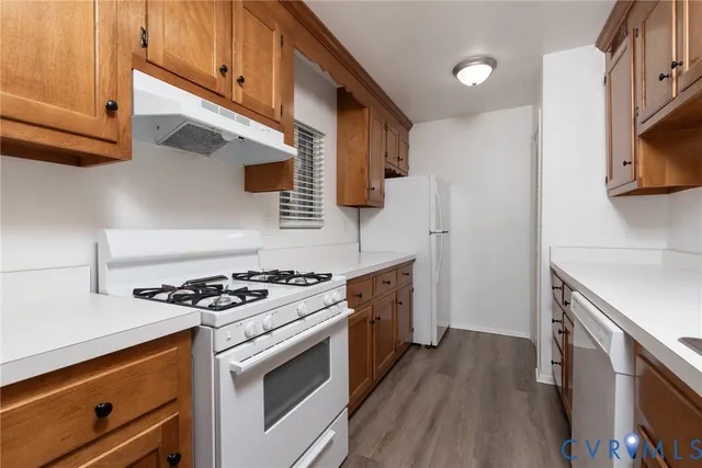 a kitchen with stainless steel appliances a stove a sink and a microwave