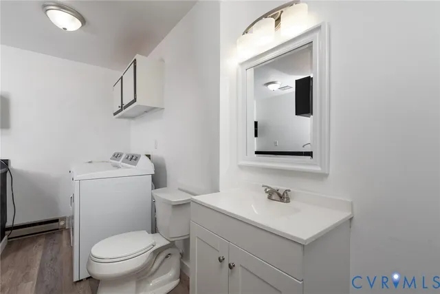 a bathroom with a sink toilet and mirror