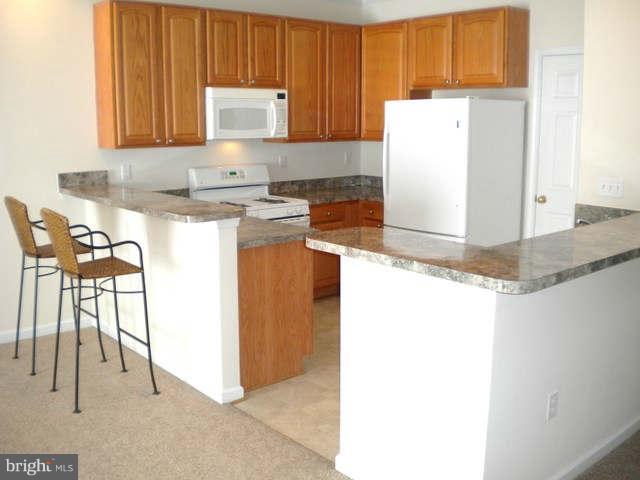 14284 Foxhall Road Dowell, MD 20629 - Photo 8 of 23 a kitchen with a refrigerator and cabinets
