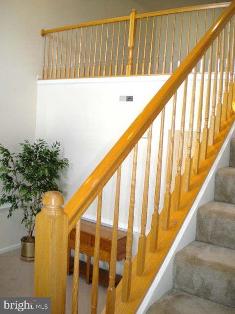 14284 Foxhall Road Dowell, MD 20629 - Photo 9 of 23 a view of staircase with railing and a potted plant