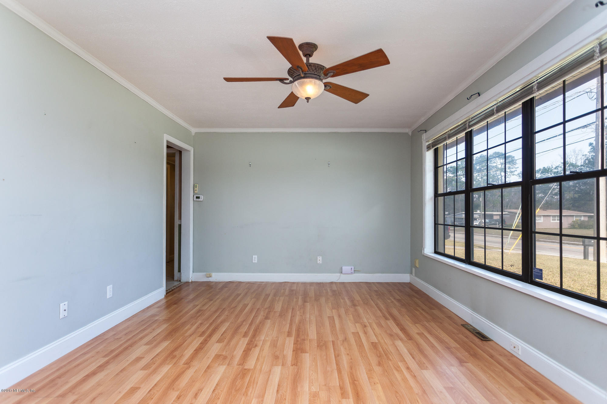 2156 Fouraker Road Jacksonville, FL 32210 - Photo 3 of 25 wooden floor in an empty room with a window