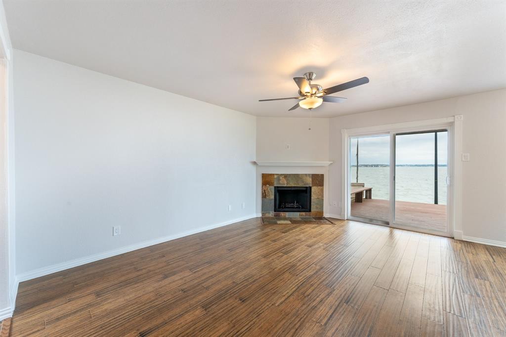 4610 Chaha Road, Unit 106 Garland, TX 75043 - Photo 8 of 25 a view of an empty room with wooden floor and a window
