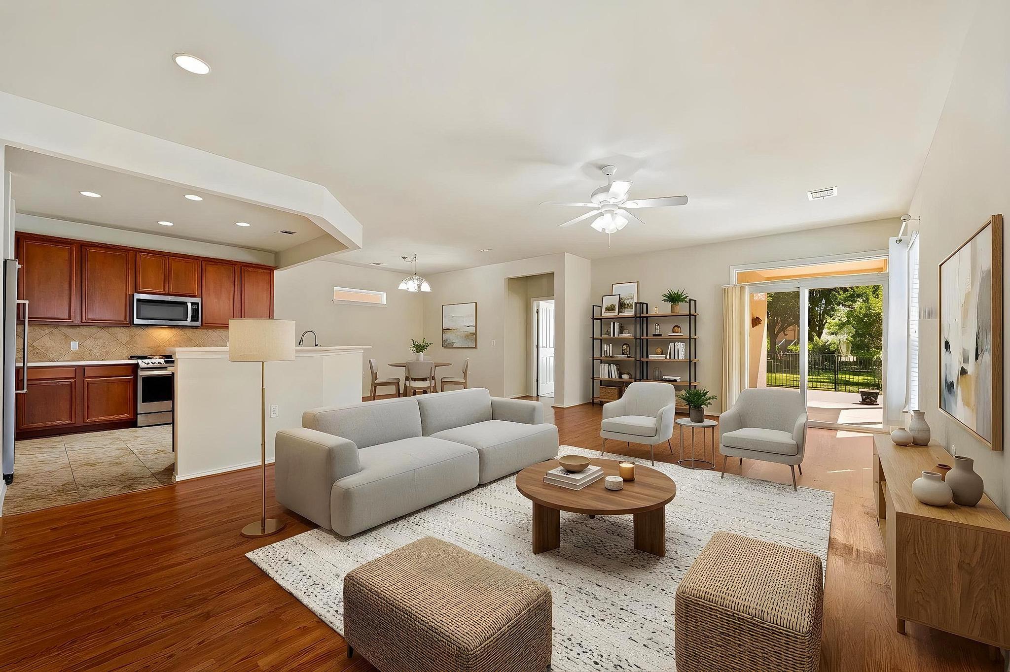 520 Mill Pond Path Georgetown, TX 78633 - Photo 12 of 38 An open concept living and dining area boasts rich hardwood like floors and a sliding glass door to the outdoors. (Virtually staged)