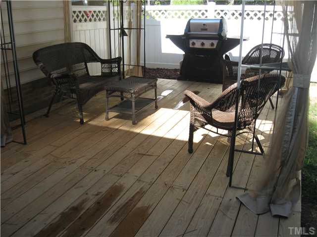 302 East Waycliff Road Henderson, NC 27537 - Photo 23 of 25 Off the screened porch is a ground-level deck