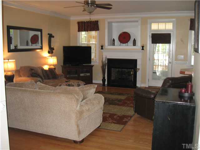 302 East Waycliff Road Henderson, NC 27537 - Photo 3 of 25 Large living area...with fireplace (gas logs included).....door to rear screened porch....hardwood flooring