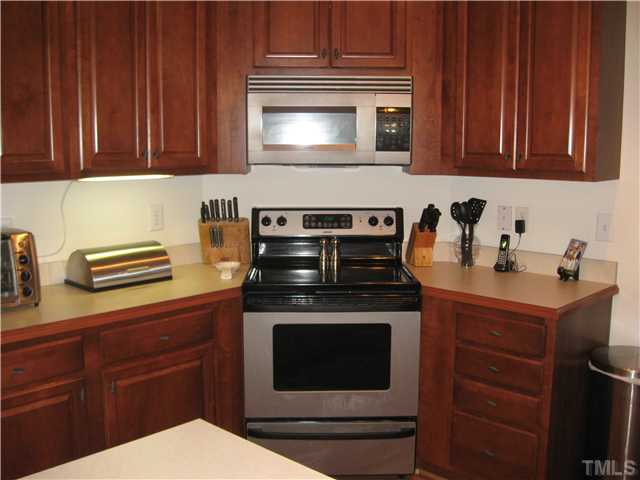 302 East Waycliff Road Henderson, NC 27537 - Photo 6 of 25 Cherry stained, maple cabinets.