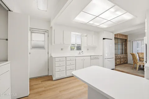 a kitchen with sink cabinets and refrigerator