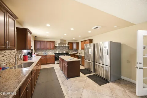 a view of a dining room with furniture and a kitchen