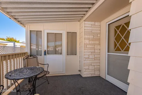 a view of a hallway with furniture and front door