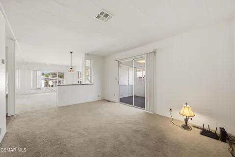 a view of kitchen and refrigerator