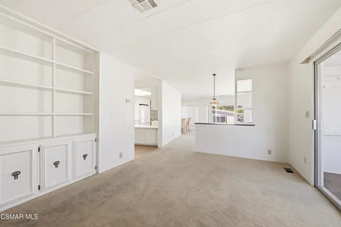 a view of a kitchen with white cabinets and wooden floor