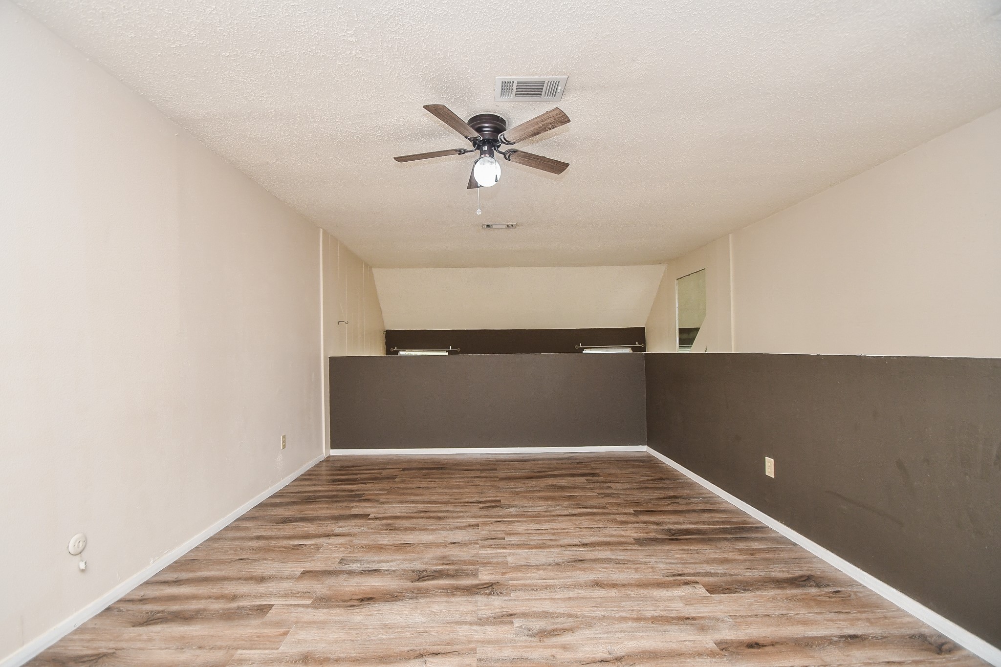 15336 West Little York Road, Unit 208 Houston, TX 77084 - Photo 12 of 33 a view of a big room with wooden floor and a ceiling fan