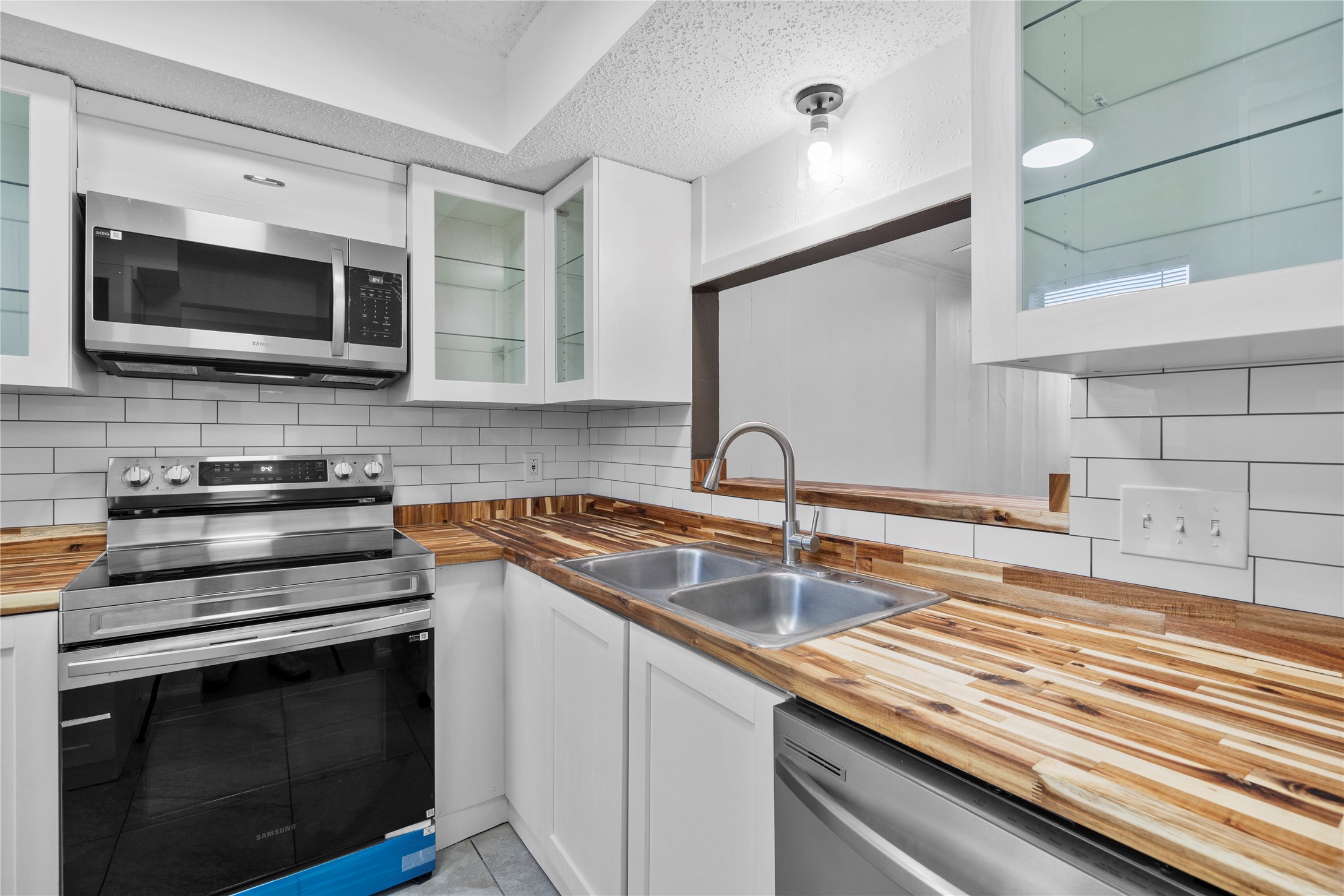 15336 West Little York Road, Unit 208 Houston, TX 77084 - Photo 19 of 33 a kitchen with stainless steel appliances a stove microwave and sink