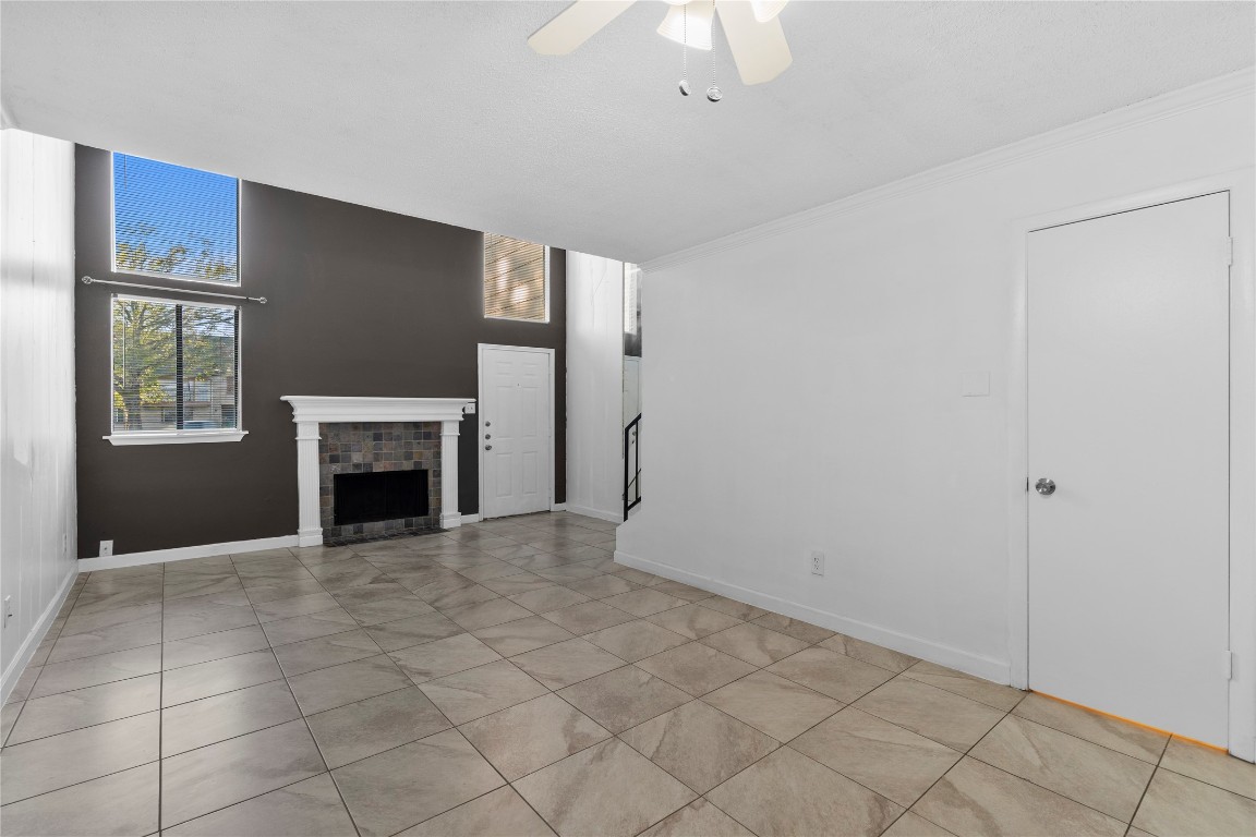 15336 West Little York Road, Unit 208 Houston, TX 77084 - Photo 22 of 33 a view of an empty room with a fireplace and a window