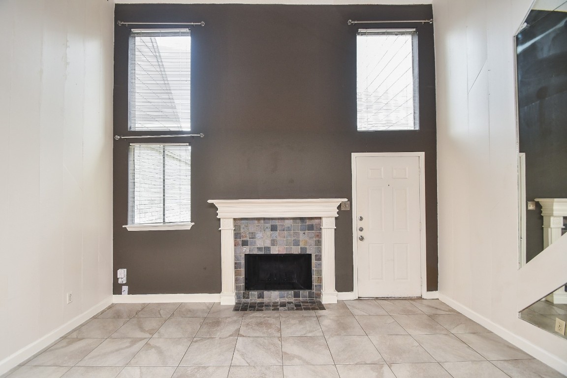 15336 West Little York Road, Unit 208 Houston, TX 77084 - Photo 10 of 33 an empty room with windows and fireplace