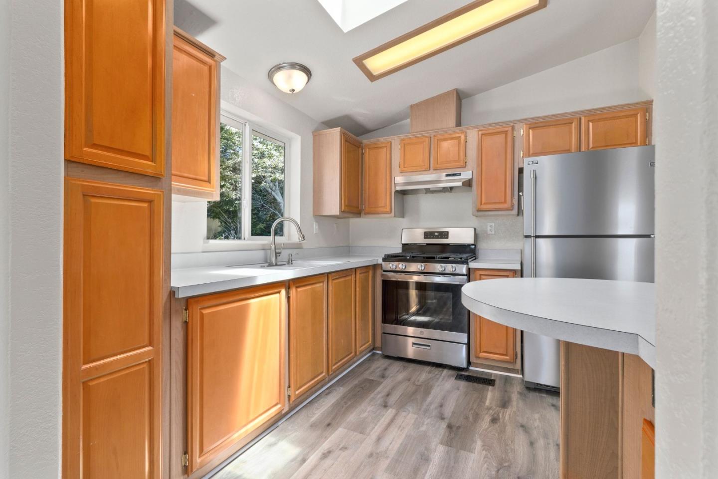 4300 Soquel Drive, Unit 96 Soquel, CA 95073 - Photo 5 of 29 a kitchen with stainless steel appliances a refrigerator and a stove top oven
