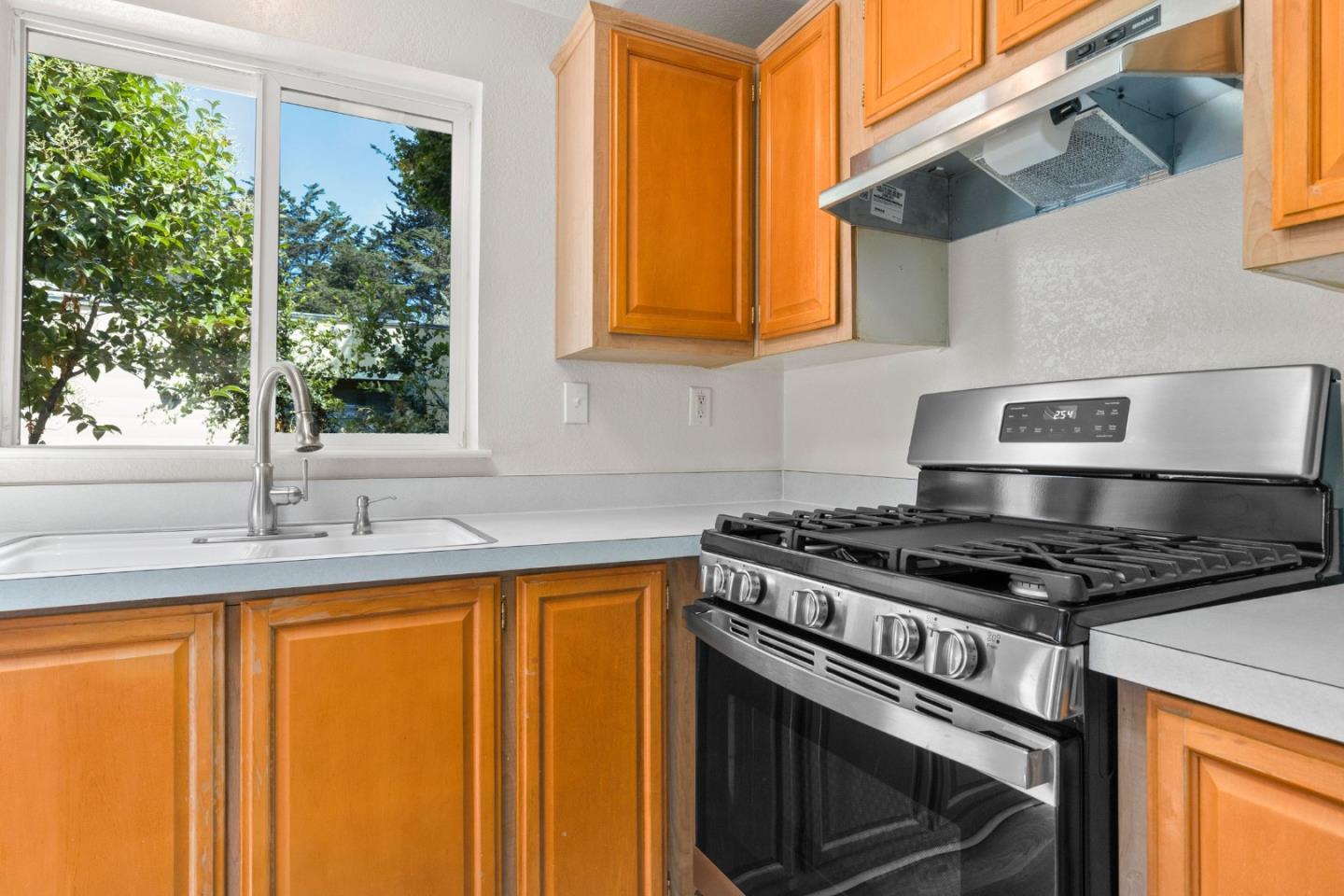 4300 Soquel Drive, Unit 96 Soquel, CA 95073 - Photo 7 of 29 a kitchen with granite countertop a sink stainless steel appliances and cabinets