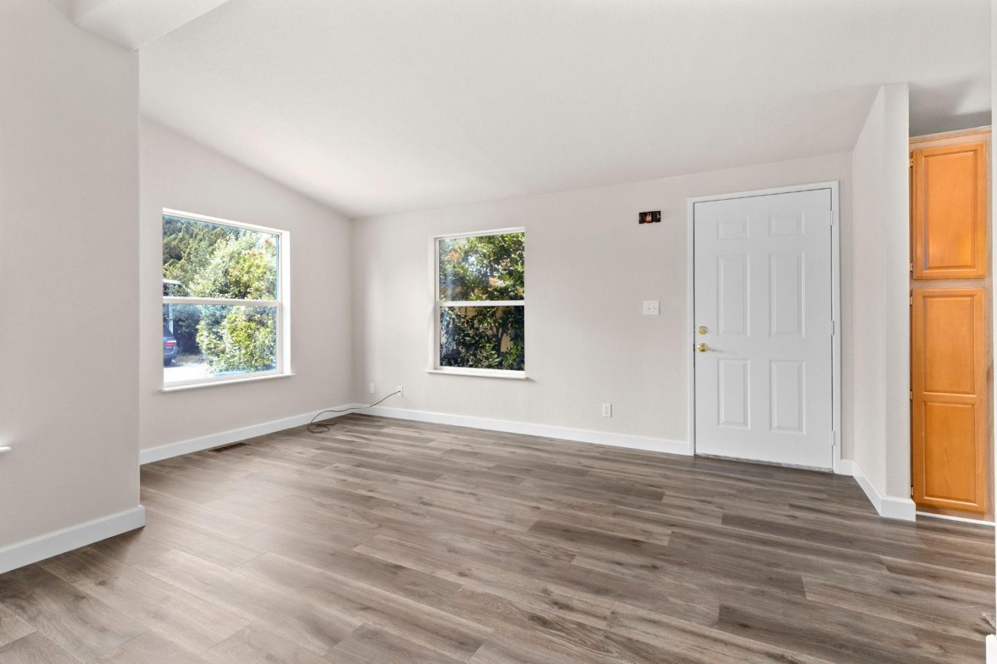 4300 Soquel Drive, Unit 96 Soquel, CA 95073 - Photo 9 of 29 an empty room with wooden floor and windows