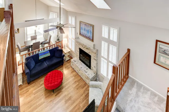 a living room with furniture fireplace and wooden floor