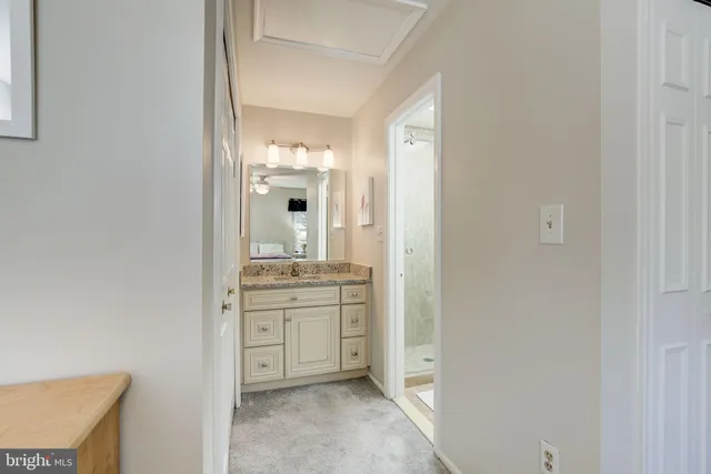a bathroom with a granite countertop sink mirror and
