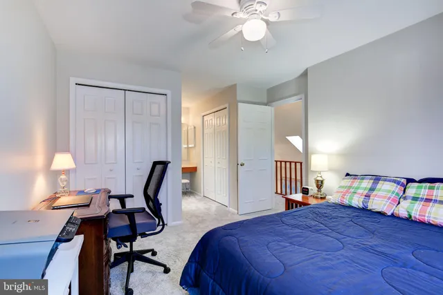 a bedroom with a bed a table and painting on the wall