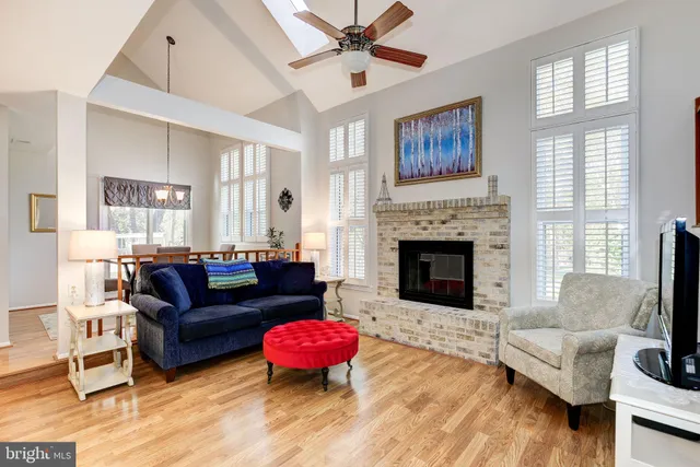 a living room with furniture fireplace and window
