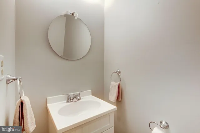 a bathroom with a sink vanity and a mirror