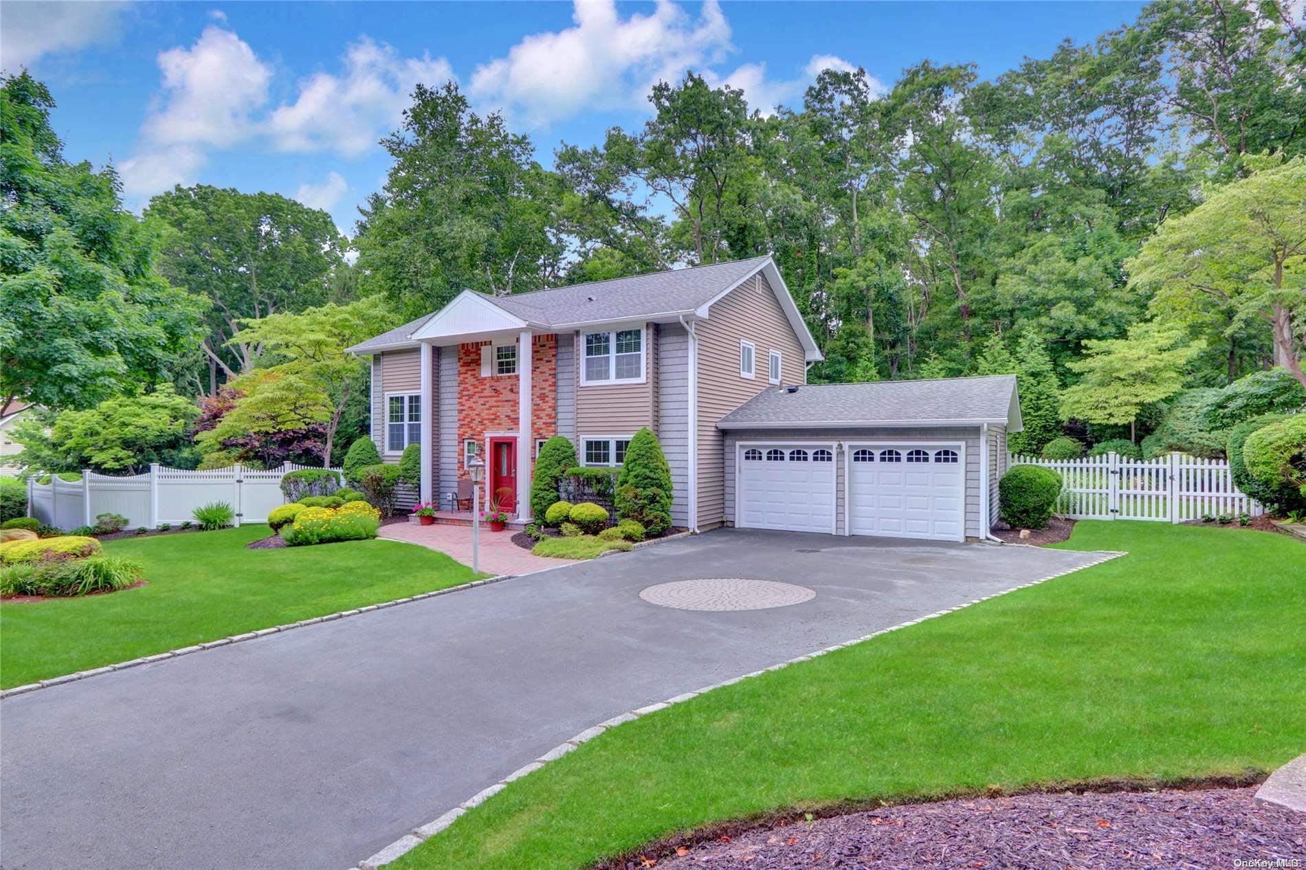 a view of a house with a yard and potted plants