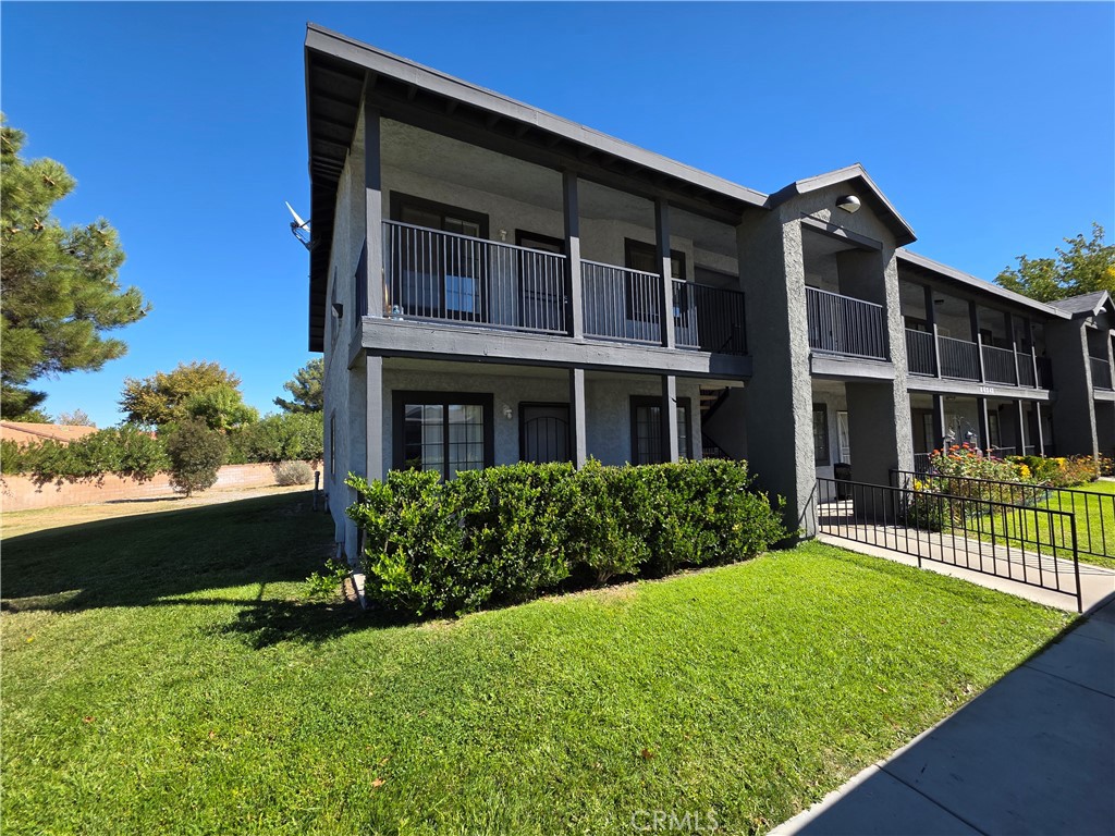 44036 25th Street West, Unit C8 Lancaster, CA 93536 - Photo 1 of 25 front view of a house with a yard