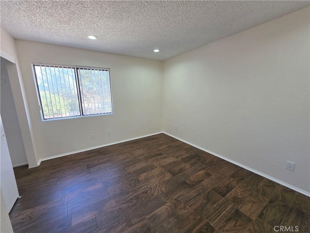 44036 25th Street West, Unit C8 Lancaster, CA 93536 - Photo 13 of 25 an empty room with wooden floor and windows