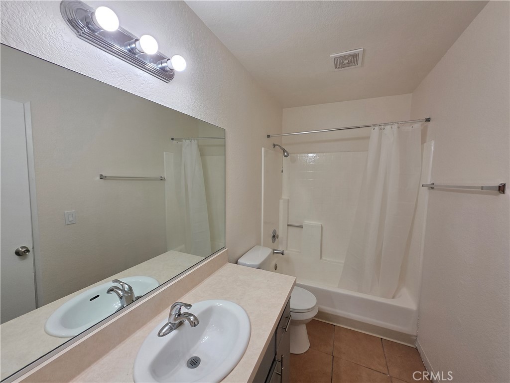 44036 25th Street West, Unit C8 Lancaster, CA 93536 - Photo 14 of 25 a bathroom with a sink a toilet and shower