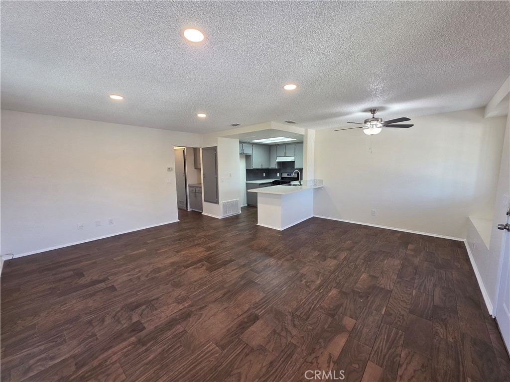 44036 25th Street West, Unit C8 Lancaster, CA 93536 - Photo 3 of 25 a view of a kitchen with a sink and a stove top oven