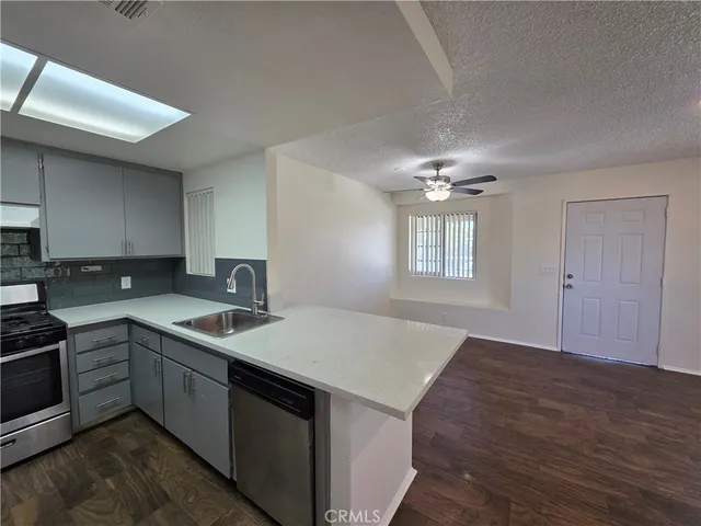 a kitchen with a sink cabinets and appliances