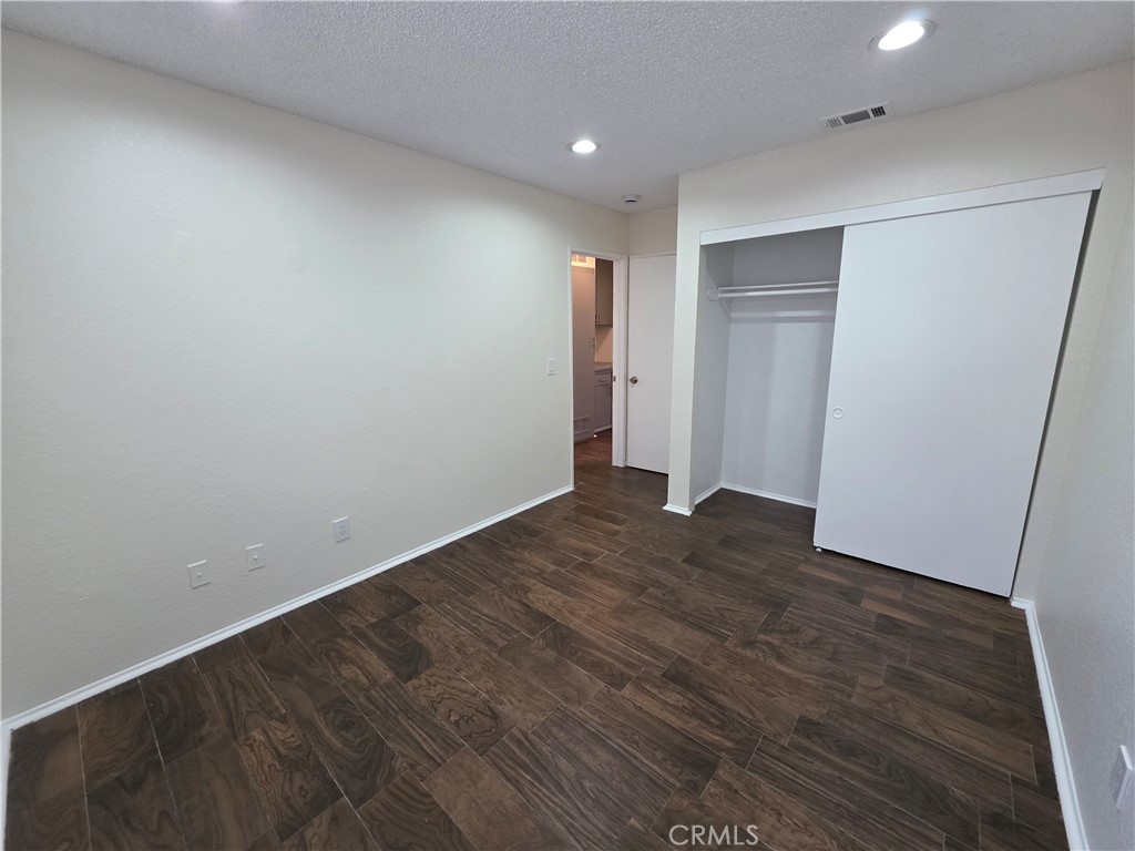 44036 25th Street West, Unit C8 Lancaster, CA 93536 - Photo 10 of 25 a view of hallway with wooden floor