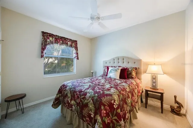 a living room with patio furniture and a chandelier