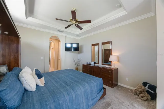 a bedroom with a large bed and a large window