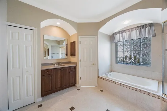 a bathroom with a sink vanity mirror and toilet